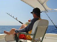 man fishing on boat in orange beach, alabama