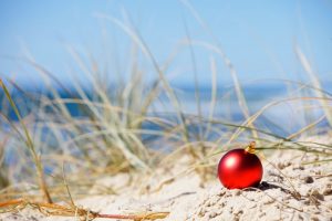 red christmas ornament in sand