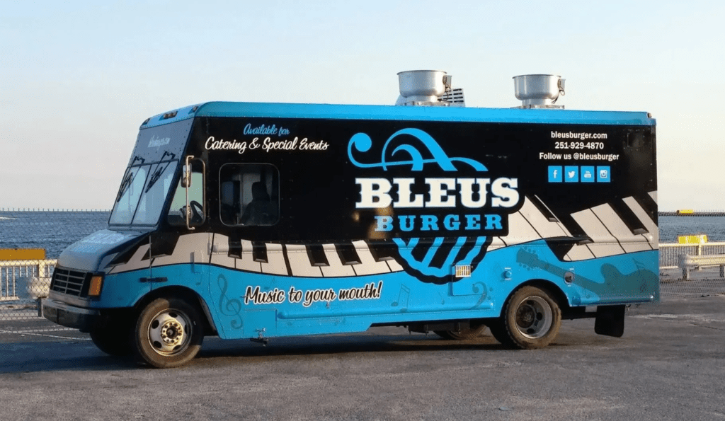 bleus burger food truck parked along the beach